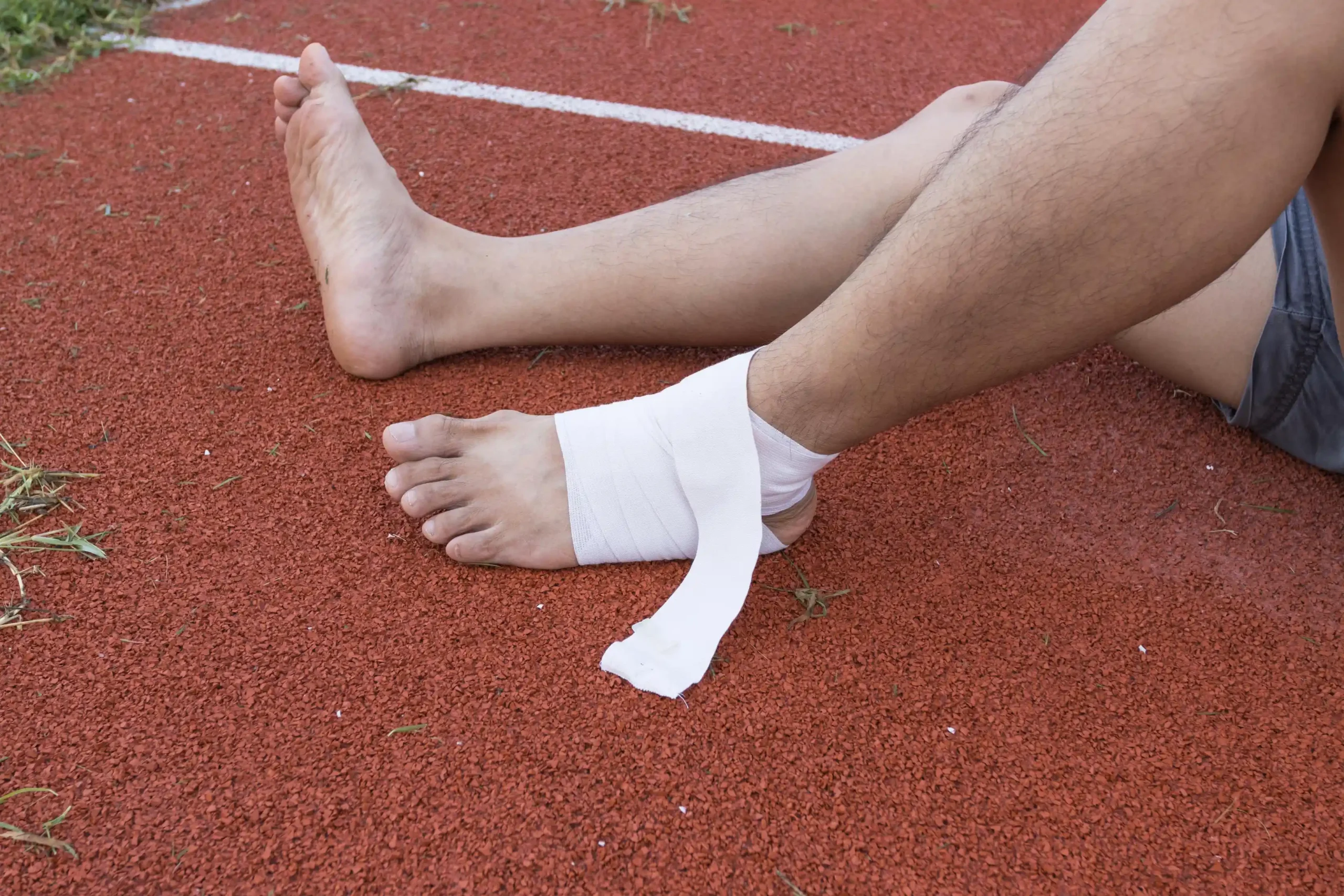 Man som applicerar kompressionsbandage på ankeln