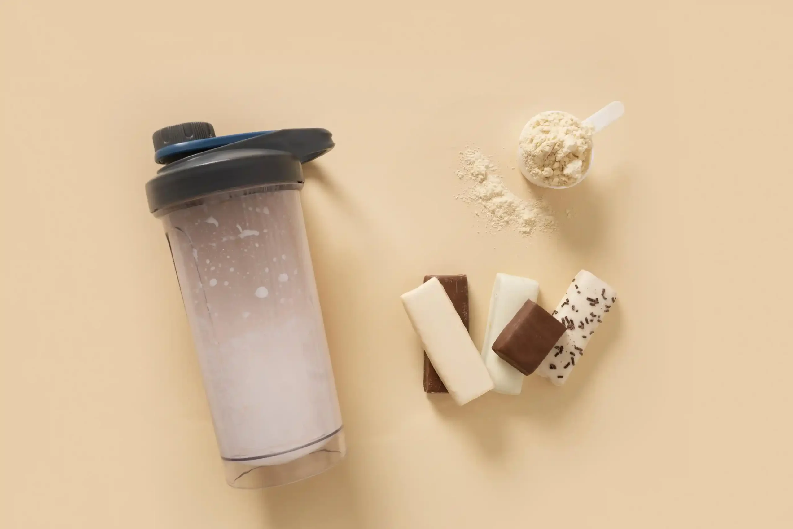 Whey protein shaker on beige background